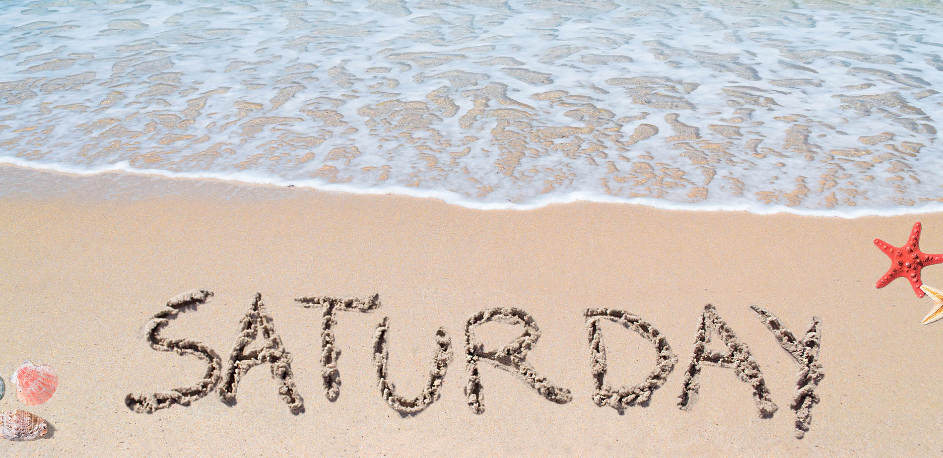 SATURDAY written into beach sand