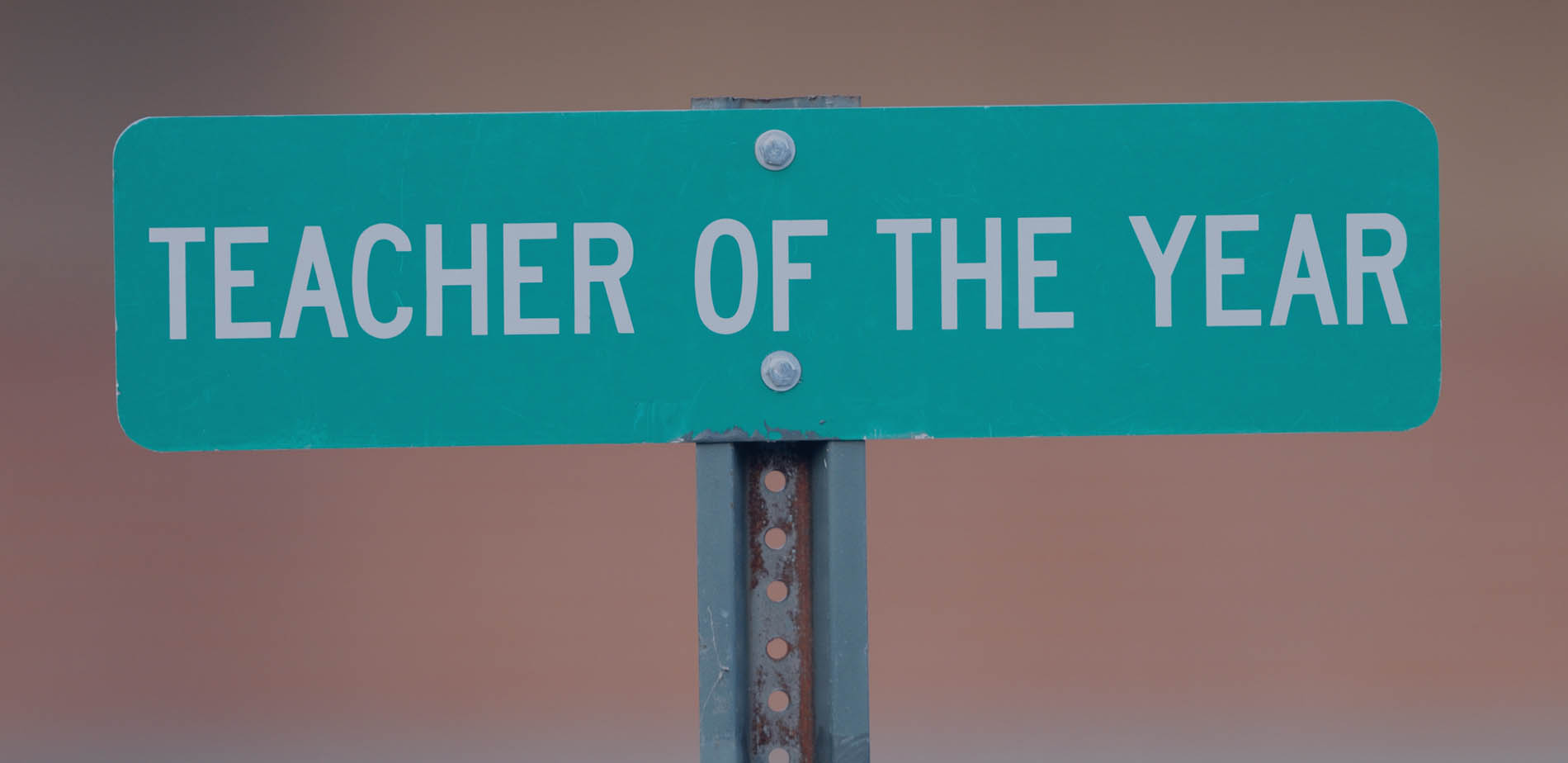 A street sign reading Teacher of the Year