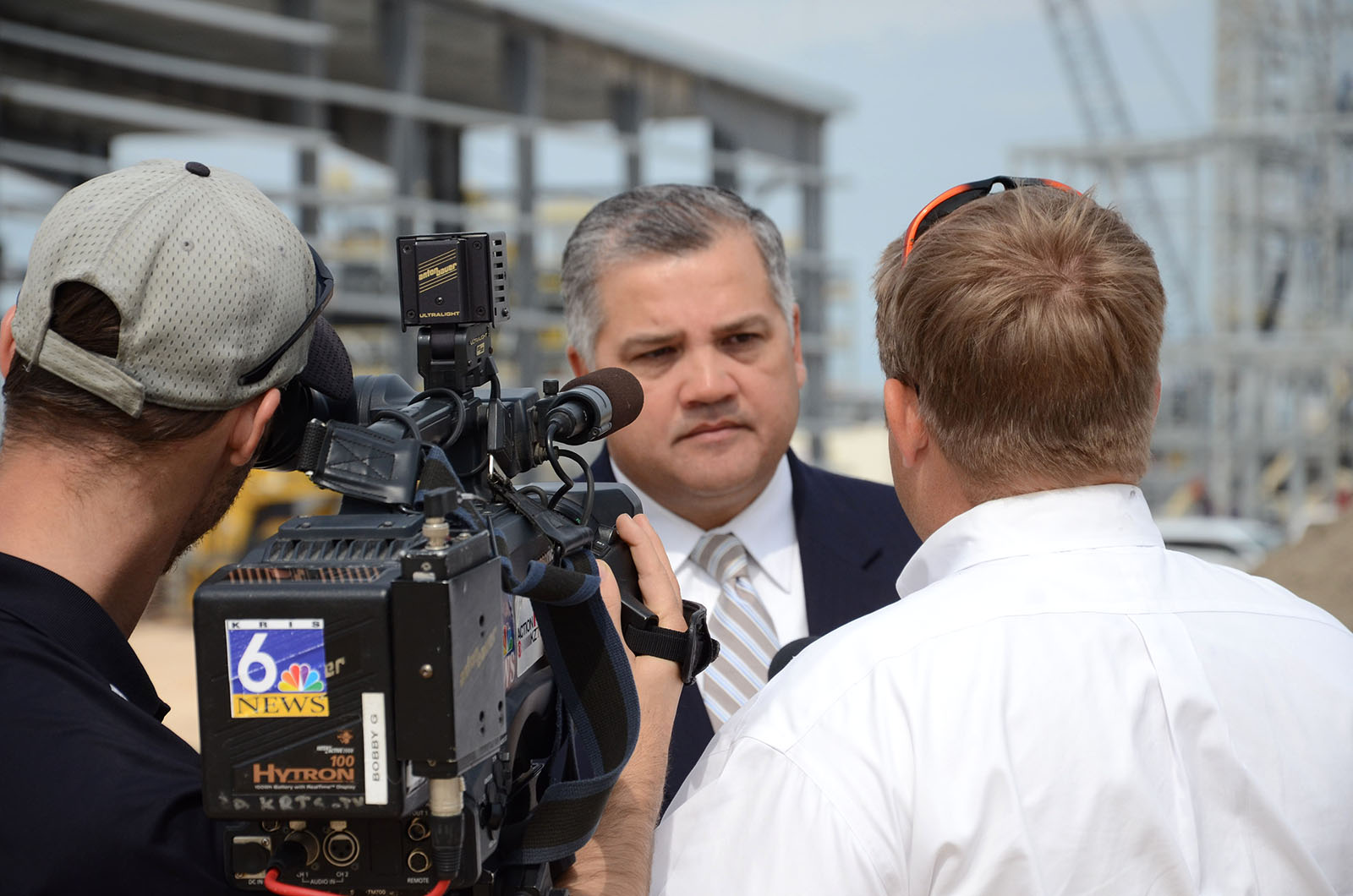 Dr. Escamilla being interviewed at news conference at industiral site
