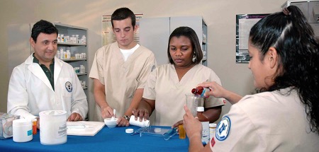 Pharmacy technician students work in a lab environment