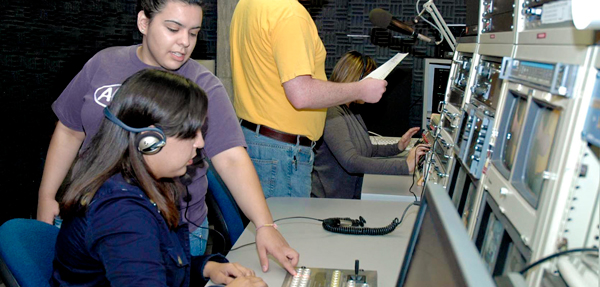 A student tries out radio and television technology.