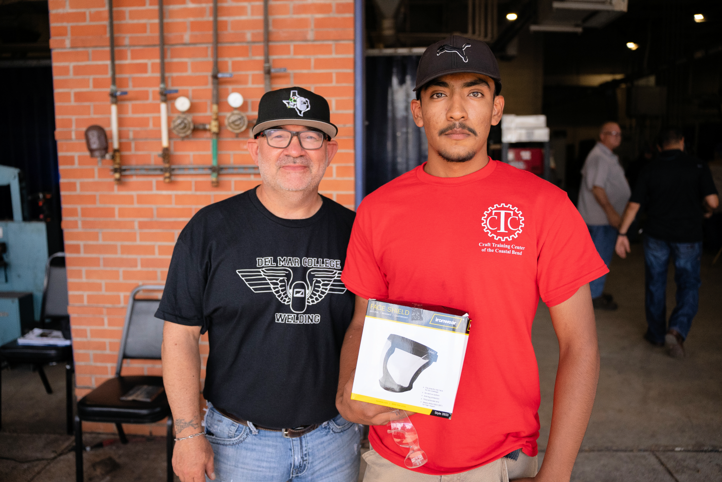 Instructor Samuel Garcia and a contestant from Craft Training Center pose for a photo