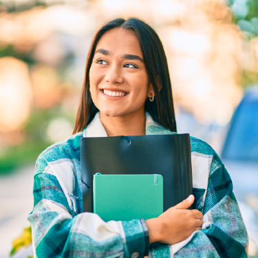 Woman smiling holding books