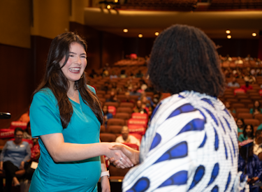 A pregnant student accepting an award at Del Mar College