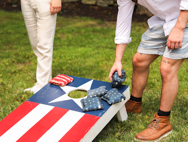 Two men playing cornhole