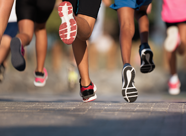 Several people running on asphalt