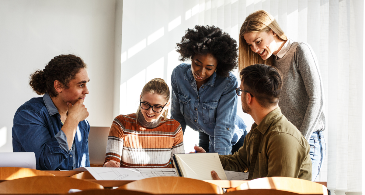 Five students studying around a table