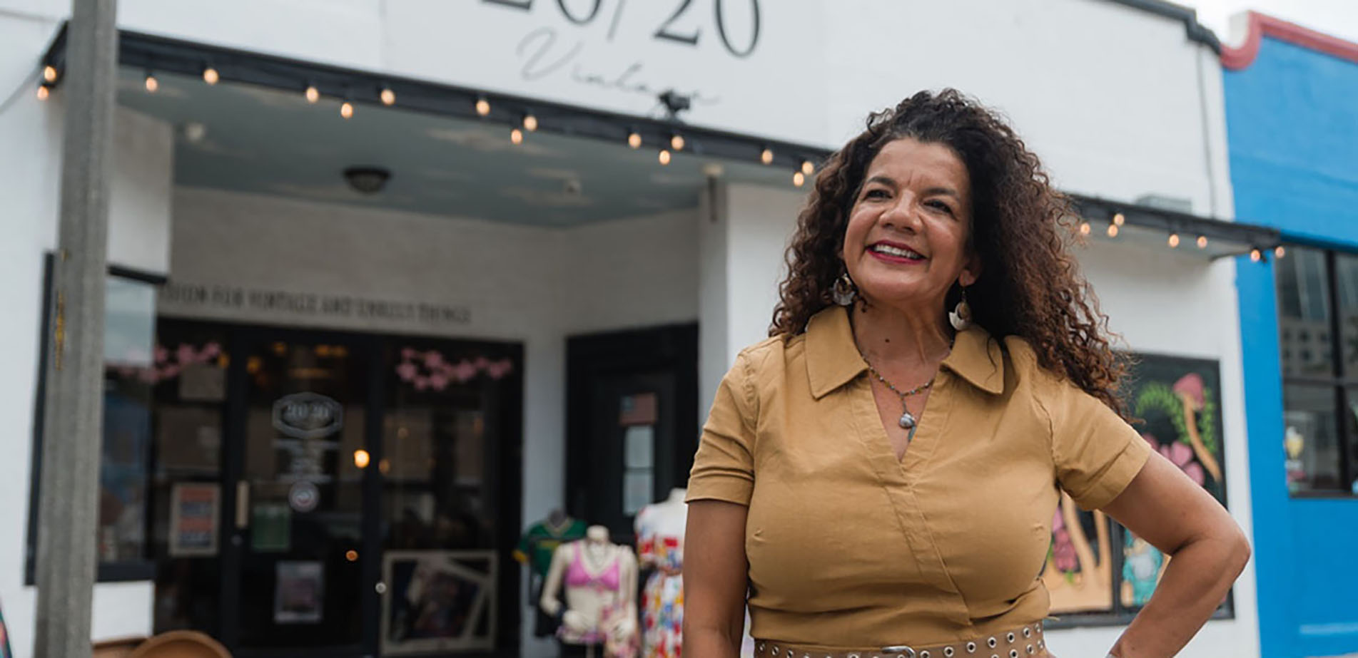 DMC Graduate Monica Ellison standing in front of her boutique